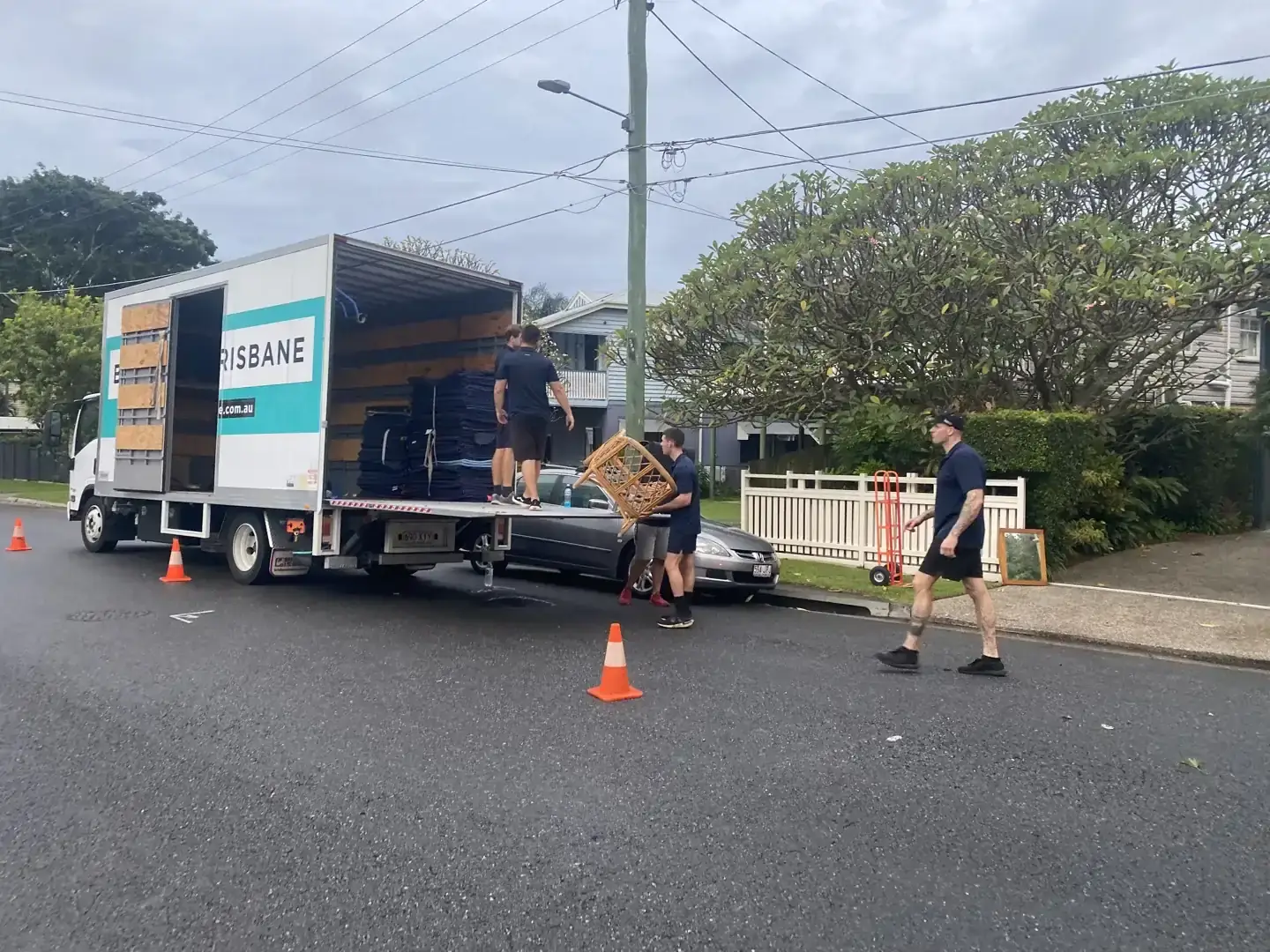 Ben Moves Brisbane removalists loading furniture from a home using a truck ramp